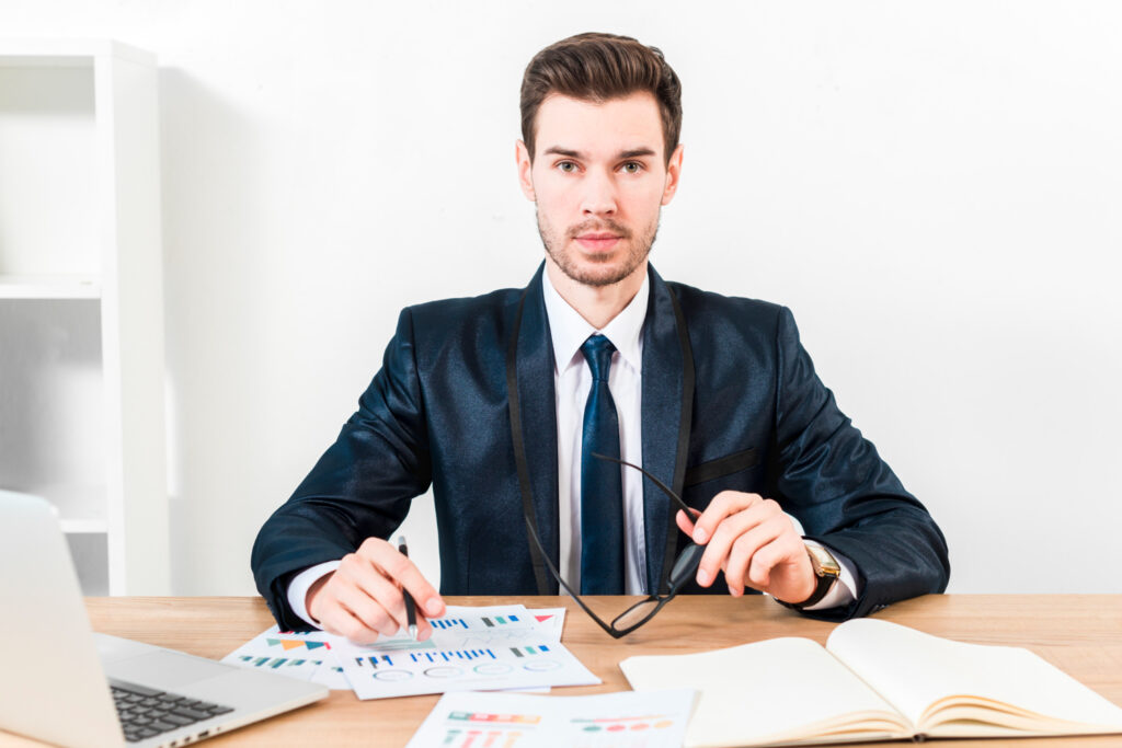 a businessman holding a pen and a eyeglass